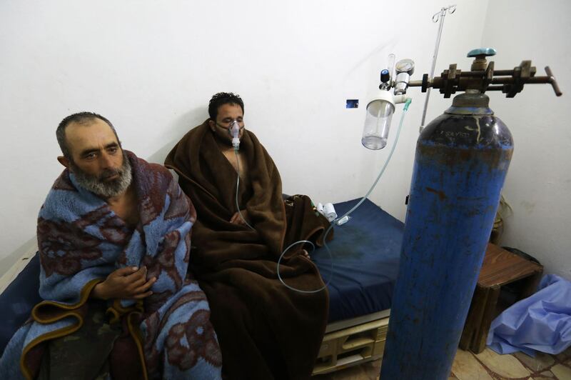 Syrians reportedly suffering from breathing difficulties following Syrian regime air strikes on the northwestern town of Saraqeb rest at a field hospital in a village on the outskirts of Saraqeb, due to the lack of hospitals in the town, on February 4, 2018.
Five people were treated for "suffocation" after Syrian regime air strikes on the northwestern town of Saraqeb, the Britain-based Syrian Observatory for Human Rights reported, adding that 10 civilians were killed in southern Idlib province. / AFP PHOTO / OMAR HAJ KADOUR