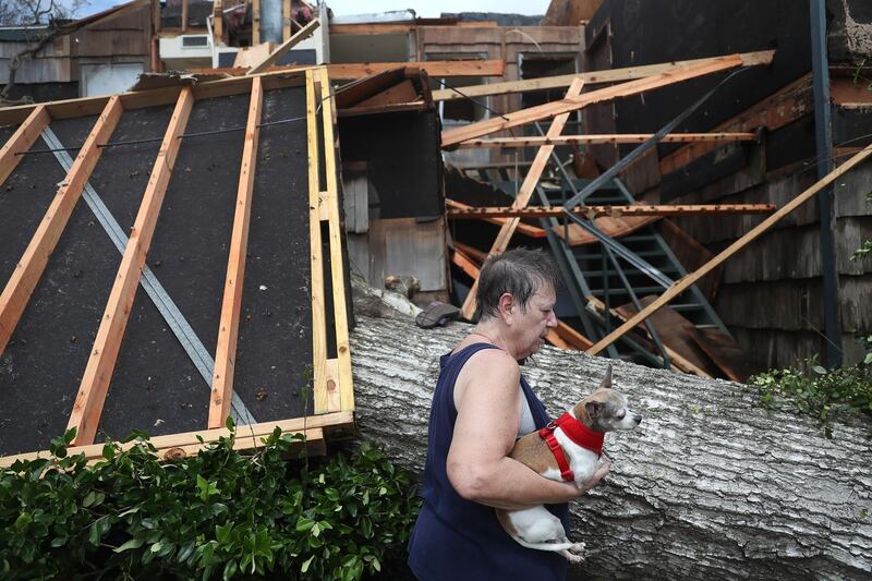 Kathy Shamburger gathers what she can from her first floor apartment that was damaged after Hurricane Laura passed through the area in Lake Charles, Louisiana. AFP
