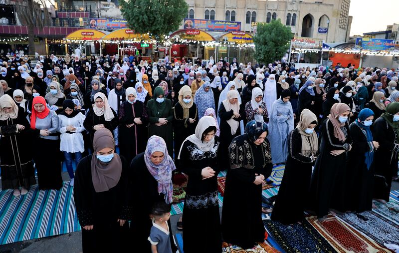 Iraqi Muslims offer Eid Al Adha prayers on the street outside Abu Hanifa Mosque in Baghdad's Adhamiya district.