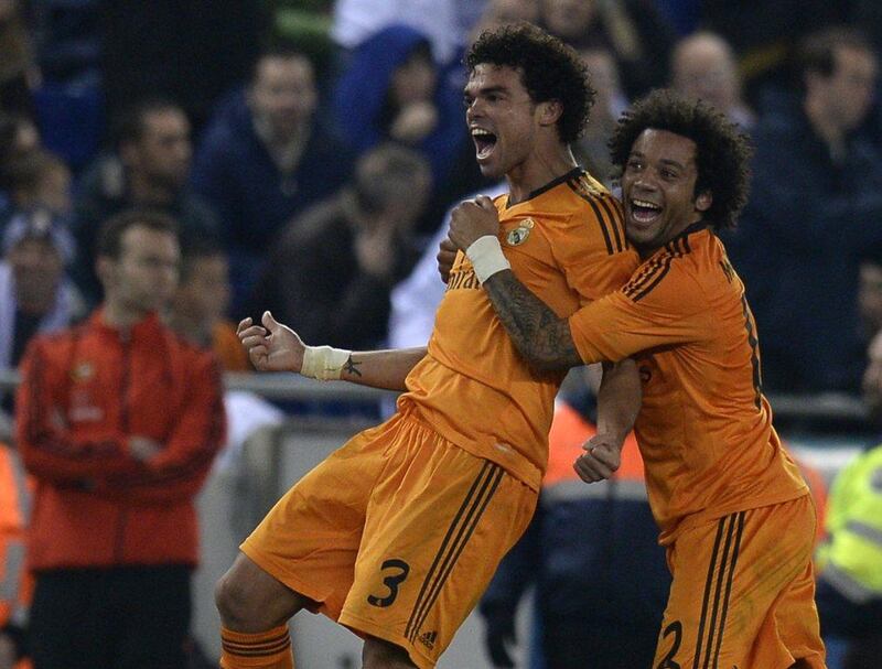Pepe, left, celebrates after scoring the winner for Real on Sunday. Lluis Gene / AFP