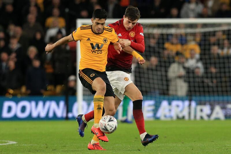 Wolverhampton Wanderers' Mexican striker Raul Jimenez (L) vies with Manchester United's Swedish defender Victor Lindelof during the FA Cup quarter-final football match between Wolverhampton Wanderers and Manchester United at the Molineux stadium in Wolverhampton, central England on March 16, 2019. (Photo by Lindsey PARNABY / AFP) / RESTRICTED TO EDITORIAL USE. No use with unauthorized audio, video, data, fixture lists, club/league logos or 'live' services. Online in-match use limited to 120 images. An additional 40 images may be used in extra time. No video emulation. Social media in-match use limited to 120 images. An additional 40 images may be used in extra time. No use in betting publications, games or single club/league/player publications. / 