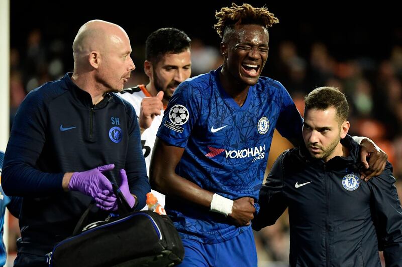 Chelsea striker Tammy Abraham is helped from the pitch after injuring his hip against Valencia in the Champions League. AFP