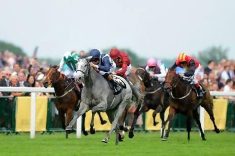 Richard Hughes rides Sky Lantern, grey horse, to victory ahead of Kenhope and Just The Judge in the Coronation Stakes during Day 4 of Royal Ascot yesterday.