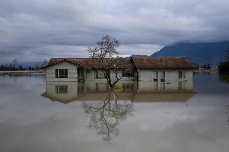 A home is reflected in floodwaters in the Yarrow neighbourhood after rainstorms caused flooding and landslides in Chilliwack, Canada on November 20, 2021. By Jesse Winter, Pulitzer Prize finalist for Feature Photography. Reuters
