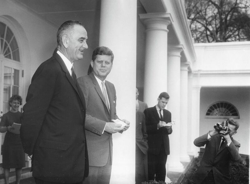 View of American politicians, Vice President Lyndon B Johnson (1908 - 1973) (left) and President John F Kennedy (1917 - 1963), as they meet with the press in the White House Rose Garden, Washington DC, March 6, 1961. President Kennedy had just signed Executive Order 10925 with required government contractors to treat all qualified employees equally 'without regard to their race, creed, color, or national origin.' (Photo by Abbie Rowe/PhotoQuest/Getty Images)