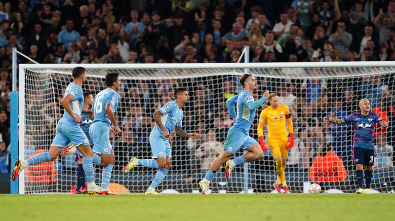 Manchester City's Jack Grealish, right, celebrates scoring his side's fourth goal against Leipzig in the Champions League at the Etihad Stadium in Manchester. PA