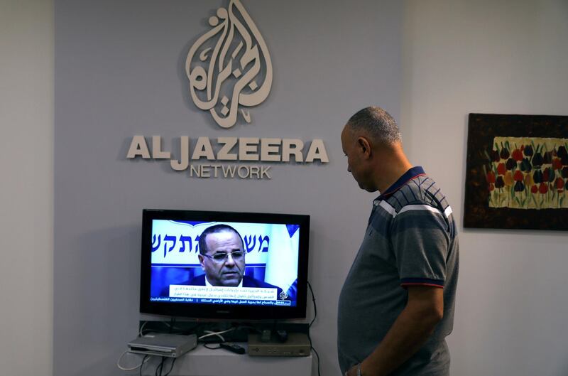 An employee working inside the office of Qatar-based Al-Jazeera network in Jerusalem August 7, 2017. REUTERS/Ammar Awad