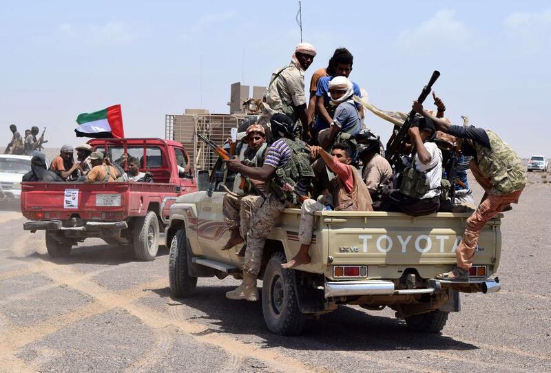 Pro-government fighters fly the flag of the UAE, a key member of a regional coalition backing Yemeni president Abdrabu Mansur Hadi, as they head from Aden towards Taez province. Saleh Al Obeidi / AFP / October 1, 2015