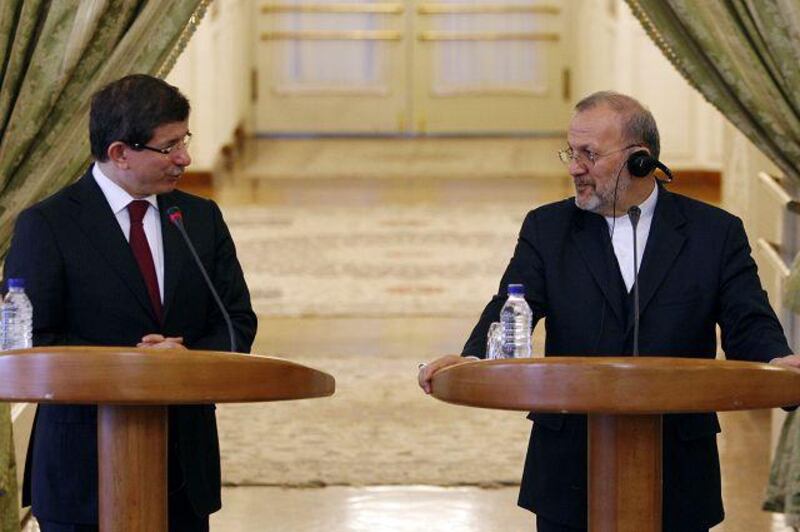 Ahmet Davutoglu, Turkey's foreign minister, left, with his Iranian counterpart, Manouchehr Mottaki, in Tehran.