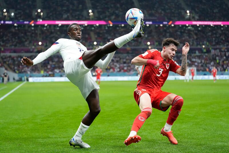 Tim Weah of the United States, left, clears the ball in front of Wales' Neco Williams. AP