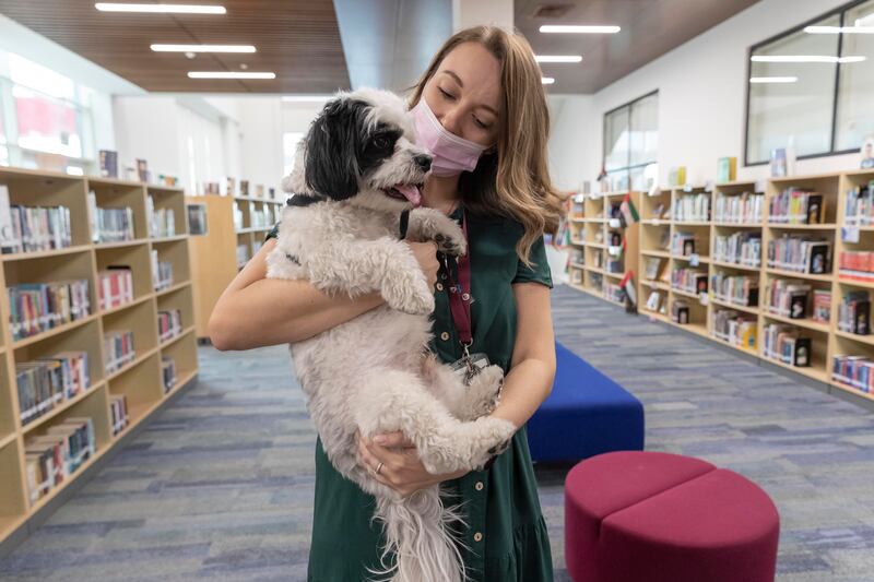 Marshall, a Bichon Frise, with his owner Laura Channer, a school counsellor at Kent College. 
