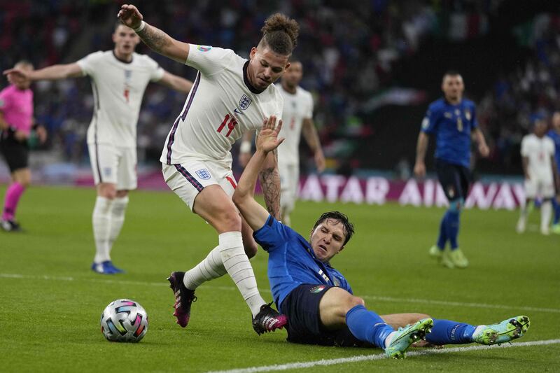 England midfielder Kalvin Phillips fights for the ball with Italy's Federico Chiesa.