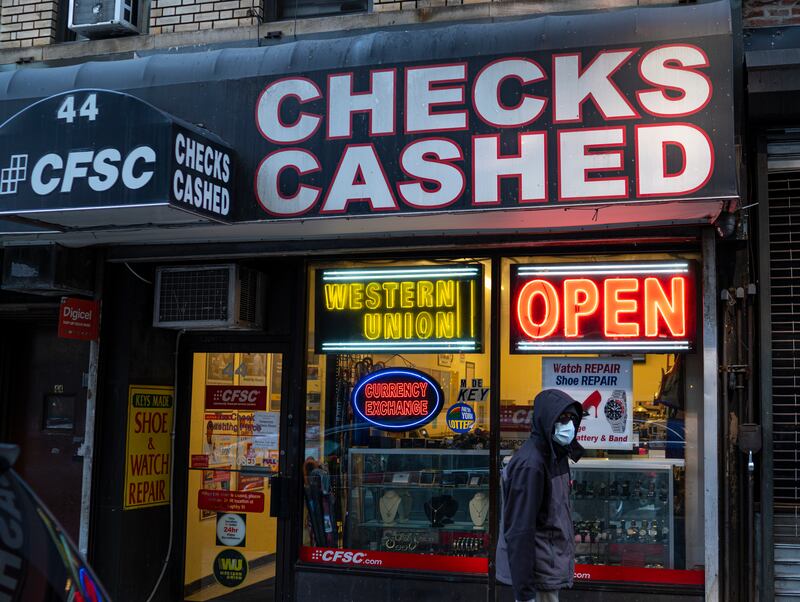 A pedestrian walks past a Western Union and check cashing store in the Brooklyn borough of New York City. Getty Images