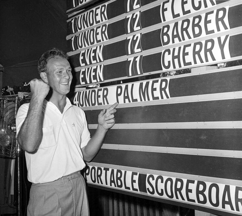 This June 19, 1960, file photo shows Arnold Palmer pointing to his name on the press tent scoreboard showing his four-under-par total, for 72 holes, during the National Open golf tournament at the Cherry Hills Country Club in Denver, Colorado. AP Photo