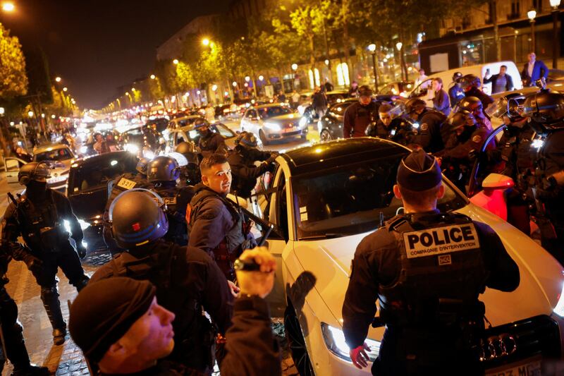 Police clash with protesters on the Champs Elysees in Paris. Reuters