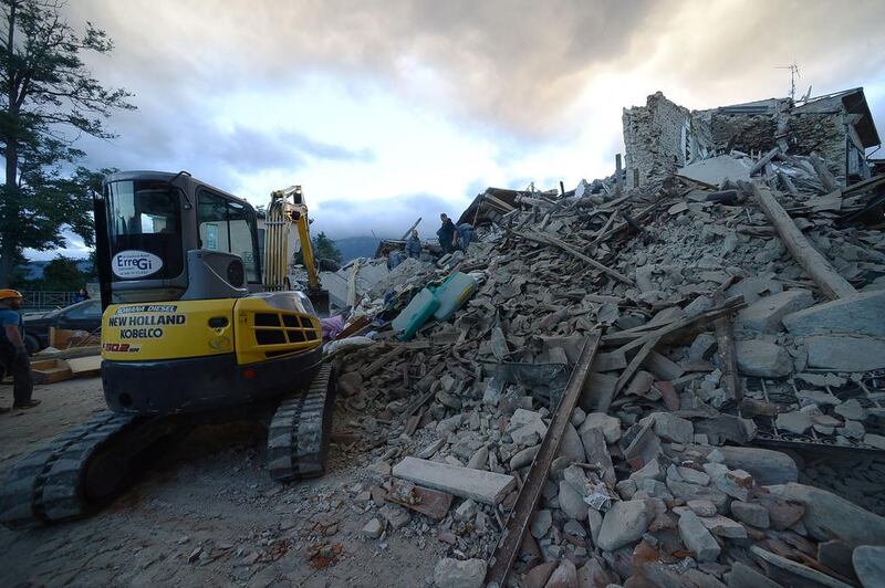 Rescuers search for victims in damaged buildings after a strong heartquake hit Amatrice. Rocks and metal tumbled onto the streets and dazed residents huddled in piazzas as some 39 aftershocks continued into the early morning hours, some as strong as 5.1. Filippo Monteforte / AFP