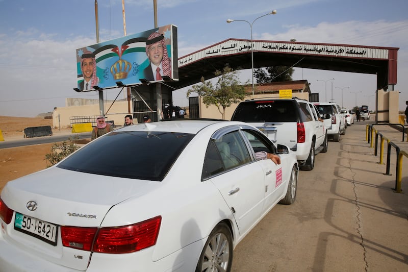 Jordanian security officials check vehicles at Jordan's Jaber border crossing with Syria. Reuters