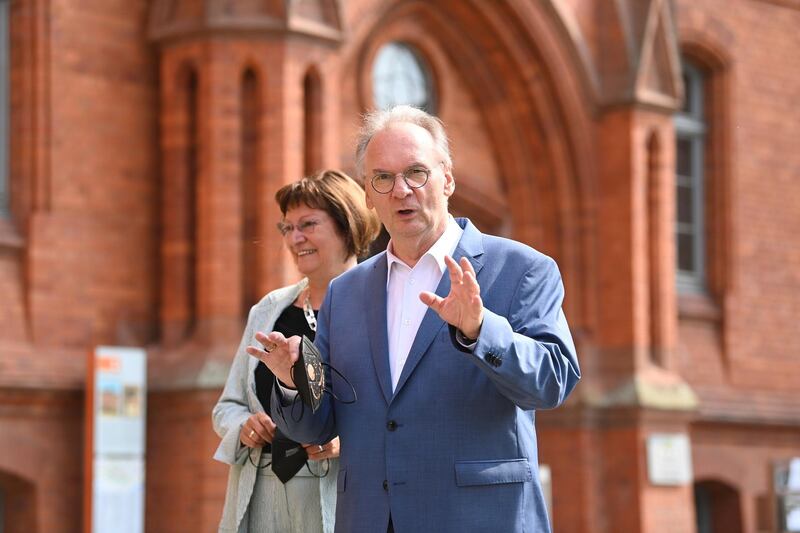 The governor of Saxony- Anhalt  Reiner Haseloff, right, of Chancellor Angela Merkel's Christian Democratic Union party, CDU, and his wife Gabriele Haseloff, arrive at the polling station during the state election in Saxony-Anhalt in Wittenberg, Germany, Sunday, June 6, 2021. The election for the new state parliament in Saxony-Anhalt is the last state election before the  national election in September 2021. (Robert Michael/dpa via AP)
