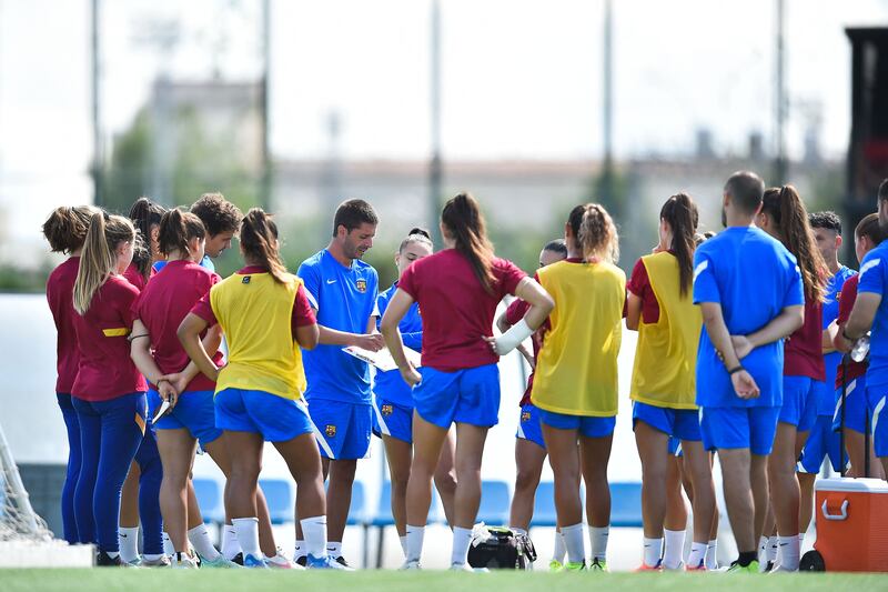 Barcelona's women's B team coach Oscar Belis heads a training session at La Masia. AFP