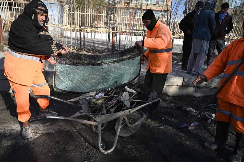 Municipal workers clear a windscreen and other debris from a street in Kabul after multiple rockets were fired in the Afghan capital. AFP