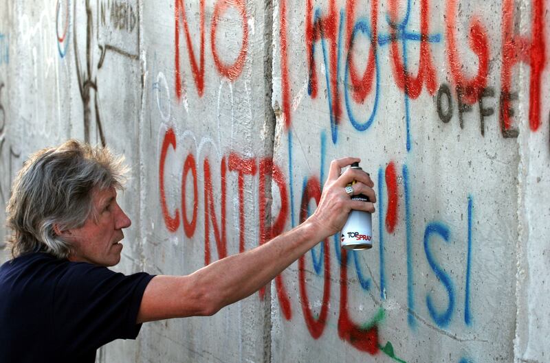 Waters spray-paints the words 'No Thought Control' on a section of Israel's separation wall in the West Bank city of Bethlehem in 2006. AP 