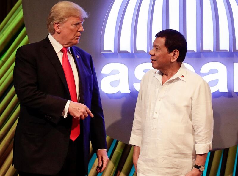 U.S. President Donald Trump, left, speaks with Philippine President Rodrigo Duterte before the opening ceremony of the 31st Association of Southeast Asian Nations (ASEAN) Summit in Manila, Philippines, Monday, Nov. 13, 2017. (Mark Cristino/Pool Photo via AP)