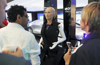 DUBAI , UNITED ARAB EMIRATES , OCT 10   – 2017 :- Visitors talking to social robot called ‘Sophia’ which is on display at the Etisalat stand during the GITEX Technology Week held at Dubai World Trade Centre in Dubai. (Pawan Singh / The National ) Story by Nicholas Webster 