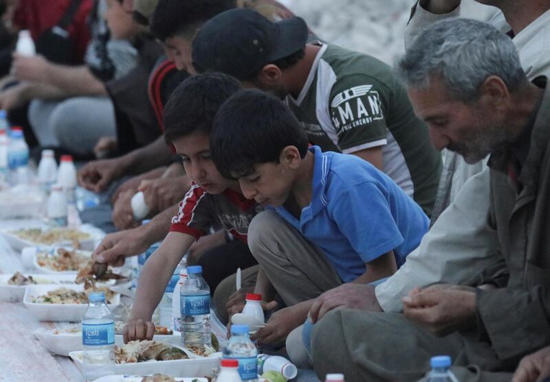 Boys eat their Iftar meal provided by a group of volunteers in a damaged neighbourhood, amid fear for the coronavirus disease outbreak, in Atarib, Aleppo countryside Syria May 7. In Syria, UNICEF is transporting clean water via lorries into some of the most devastated cities and IDP camps, but this is only a temporary solution and further highlights the need for better water management to combat future viral outbreaks. Khalil Ashawi / Reuters