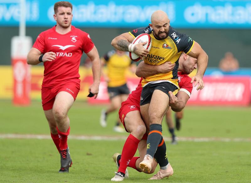 Dubai, United Arab Emirates - December 07, 2019:  Tim Richards of Hurricanes beats the defence of Bahrain during the game between Dubai Hurricanes vs Bahrain in the Gulf mens final in the HSBC rugby sevens series 2020. Saturday, December 7th, 2019. The Sevens, Dubai. Chris Whiteoak / The National