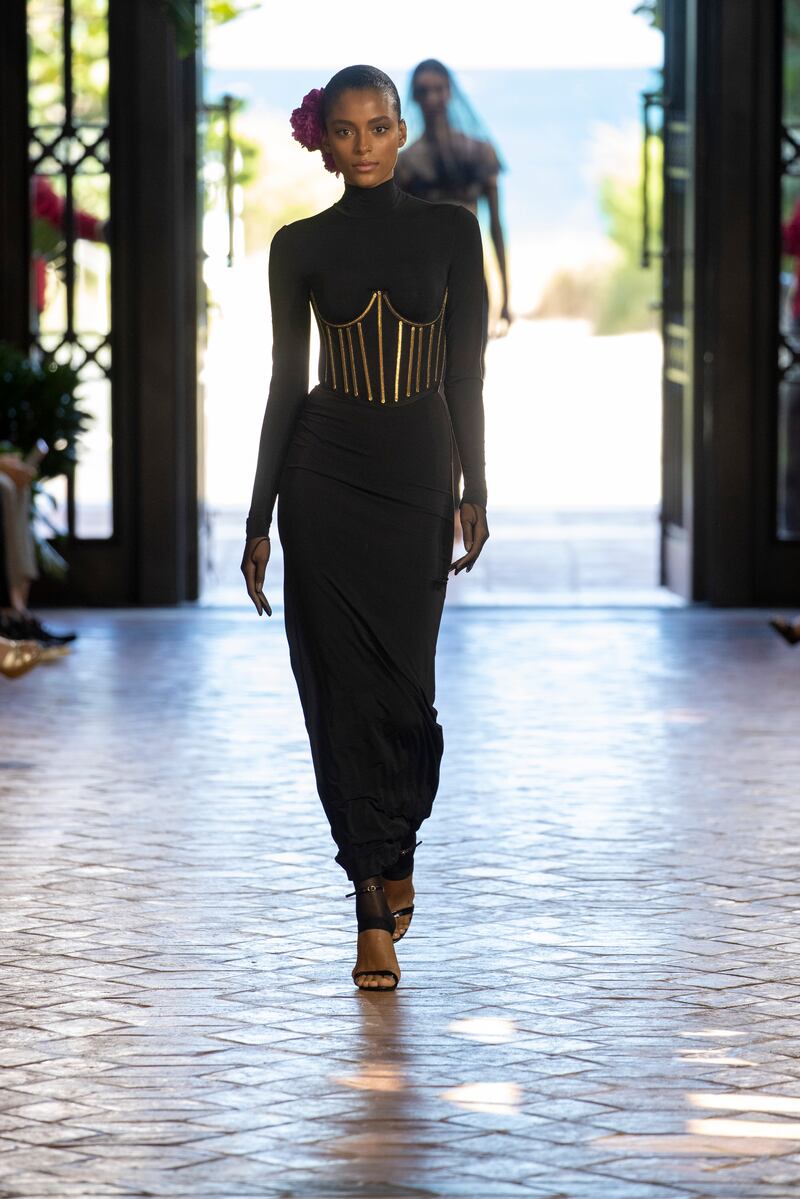 A simple dress is cinched with the gilded bars of a corset for Alta Moda