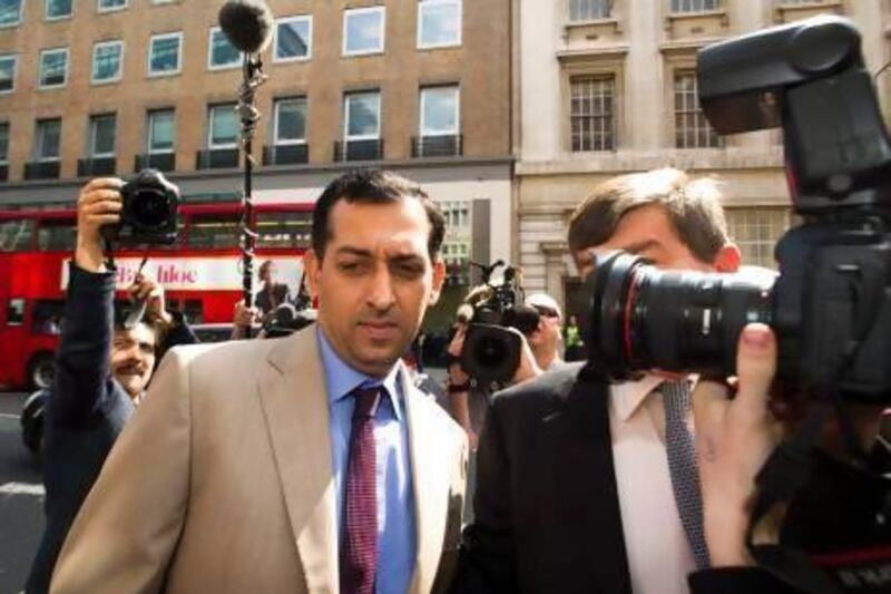 Godolphin trainer Mahmood Al Zarooni, left, found a sea of photographers waiting for him as he arrives to his disciplinary meeting with the British Horseracing Authority in London. Al Zarooni was later handed an eight-year ban for using banned substances on his horses.