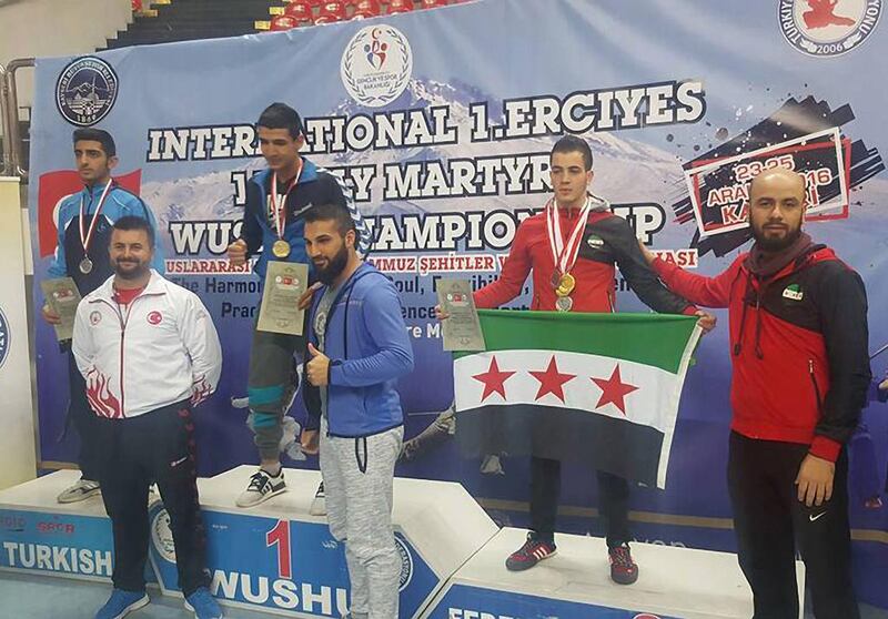 Mohammed Mustafa (second from right), a member of the Free Syrian Body of Sports’ Wushu Kung Fu team, pictured with the flag and his medals — three gold, one silver and one bronze — at the Kayseri International Championship in Kayseri, Turkey on December 25, 2016. Courtesy Public Authority for Sports and Youth in Syria