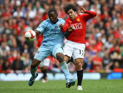 Nedum Onuoha of Manchester City battles for the ball with Carlos Tevez of Manchester United on May 10, 2009. Getty