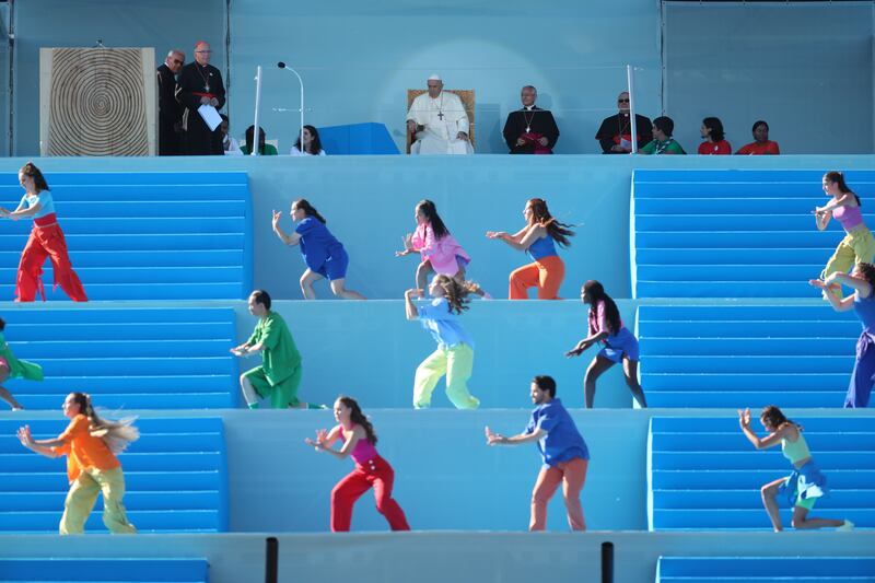 LISBON, PORTUGAL - AUGUST 3: Pope Francis watches the performance of a dance group on the stage on the Meeting Hill at Parque Eduardo VII on August 3, 2023 in Lisbon, Portugal. Pope Francis visits Portugal for World Youth Day (WYD) which takes place over the first week of August.  WYD is an international Catholic rally inaugurated by  St. John Paul II to invigorate young people in their faith. Pope Francis will travel around Portugal during his five-day visit holding masses and confessions for young people and meeting Portuguese catholic clergy members, he will also visit The Shrine of Our Lady of Fatima. (Photo by Andre Kosters - Pool / Getty Images)