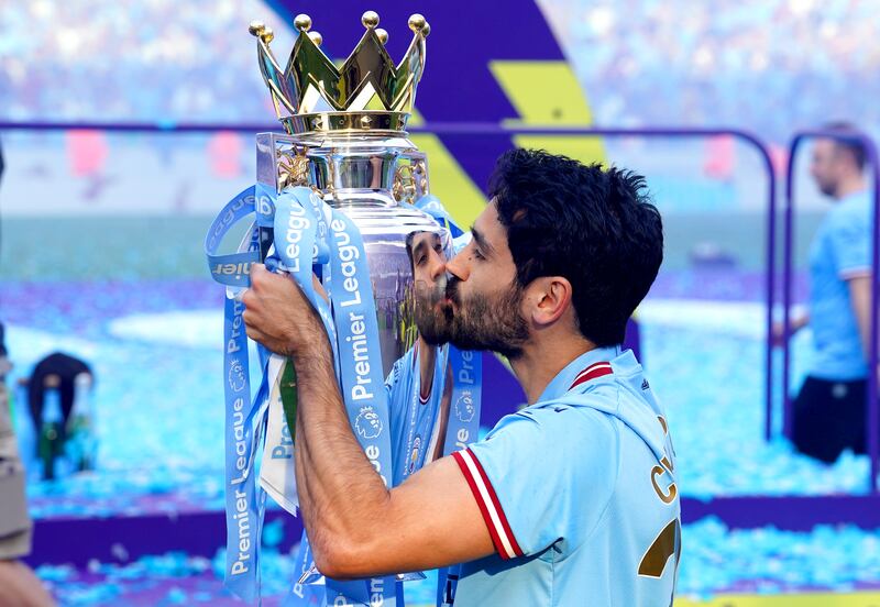 Ilkay Gundogan kisses the Premier League trophy. PA