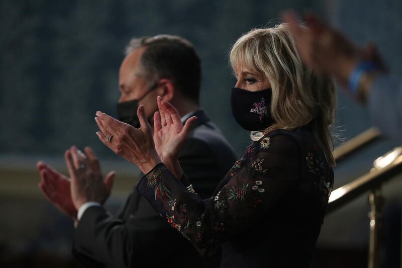 U.S. First Lady Jill Biden, right, and Second Gentleman Douglas Emhoff react as U.S. President Joe Biden, not pictured, speaks during a joint session of Congress at the U.S. Capitol in Washington, D.C., U.S., on Wednesday, April 28, 2021. Biden will unveil a sweeping $1.8 trillion plan to expand educational opportunities and child care for families, funded in part by the largest tax increases on wealthy Americans in decades, the centerpiece of his first address to Congress. Photographer: Michael Reynolds/EPA/Bloomberg