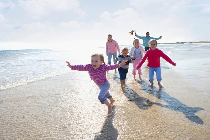 Young happy family running on beach (Getty Images) *** Local Caption ***  wk15ap-family-main.jpg
