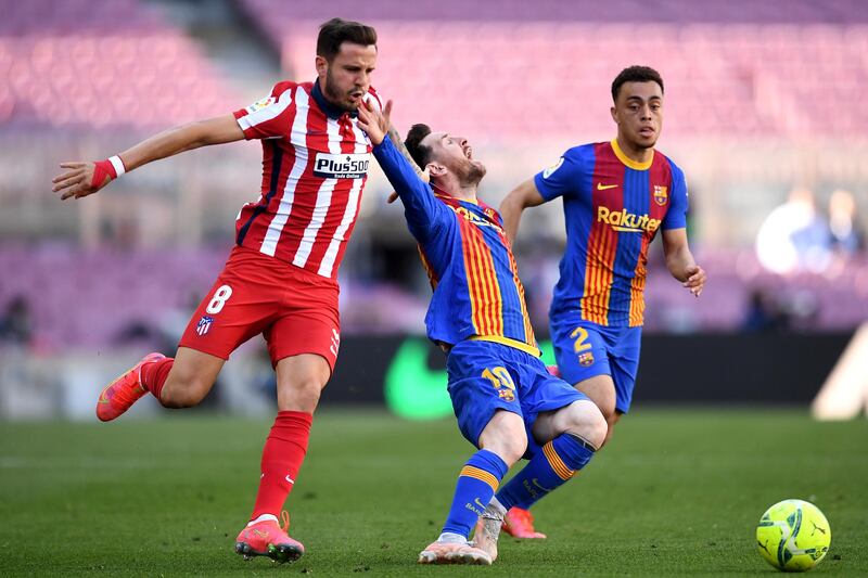 Barca's Lionel Messi is fouled by Sauel Niguez of Atletico Madrid. Getty