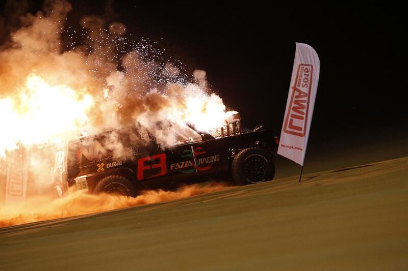 A modified off-road vehicle catches fire during sand dune drag racing event in the Liwa desert. Karim Sahinb / AFP Photo