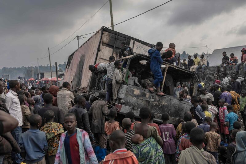 Residents dismantle a vehicle belonging to a UN mission in the Democratic Republic of Congo. AFP

