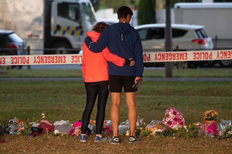 A lady stands near tributes across the road from the Dean Avenue mosque on March 17, 2019. AFP