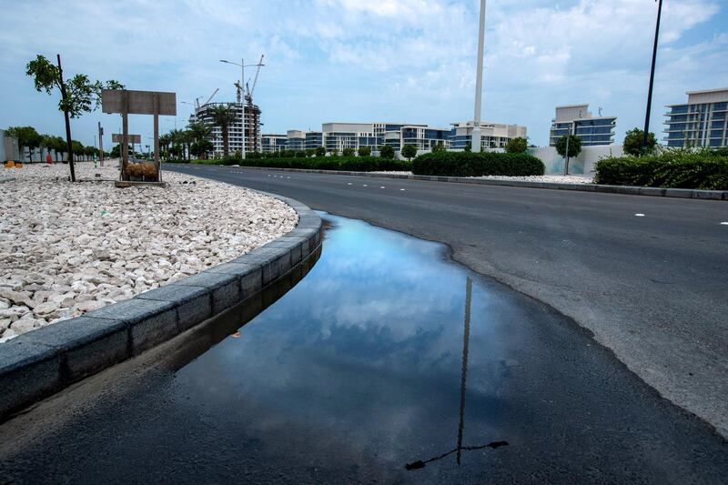 Puddles from the brief rainshowers gather on the gutters and roads in Saadiyat Island on April 28, 2021.  Victor Besa / The National.