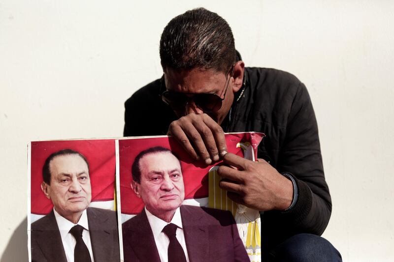 A supporter of former Egyptian President Hosni Mubarak weeps outside of Mosheer Tantawy mosque before his funeral. AP Photo