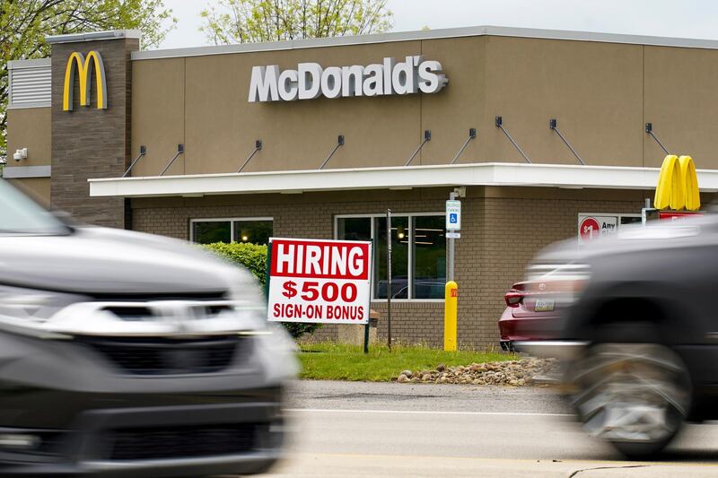 A hiring sign offers a $500 bonus outside a McDonalds restaurant, in Cranberry Township, Butler County, Pa., Wednesday, May 5, 2021.  U.S. employers posted a record number of available jobs in March, starkly illustrating the desperation of businesses to hire more people as the economy expands. Yet total job gains increased only modestly that month, according to a Labor Department report issued Tuesday, May 11. (AP Photo/Keith Srakocic)