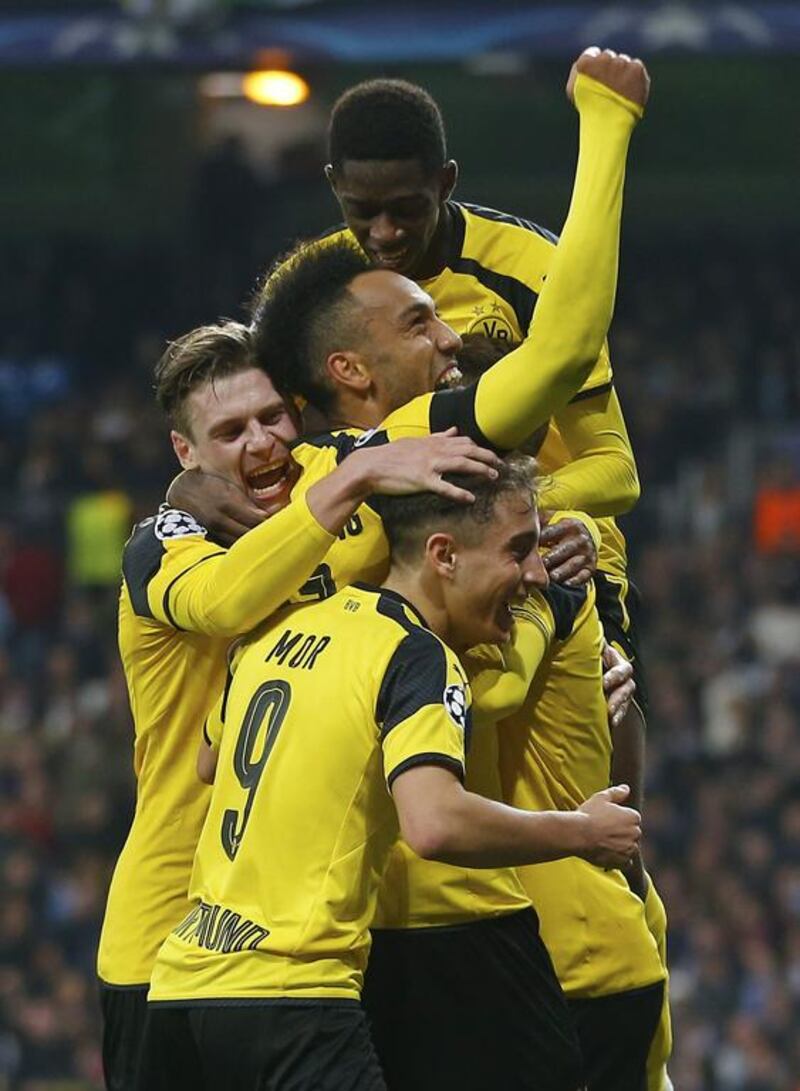 Dortmund players celebrate after Marco Reus scored his side's 2nd goal against Real Madrid. Francisco Seco / AP