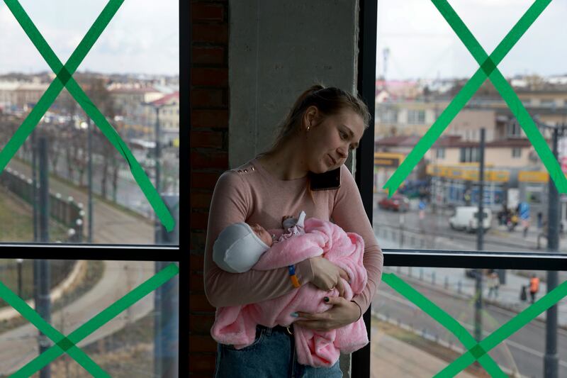 Irina Szymanska holds her baby in a temporary shelter at the central train station for displaced people heading to Poland in Lviv, Ukraine. Getty Images