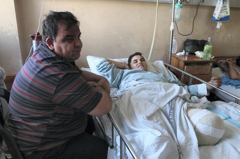 Bashir Faraj and his father Mohammed in Gaza's Al Shifa hospital, June 6, 2018. Florian Neuhof for The National