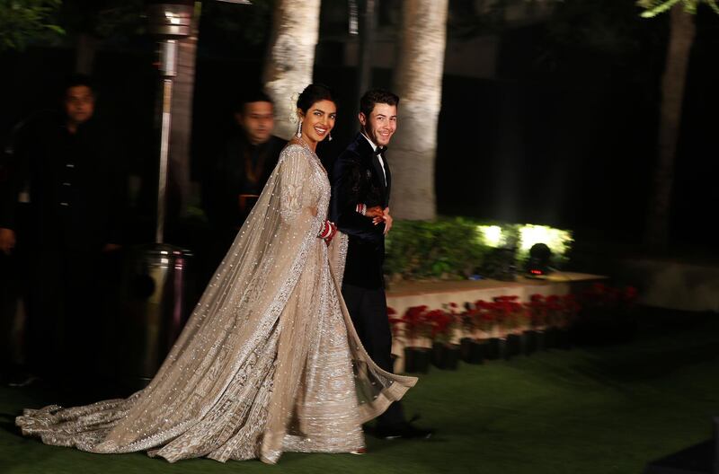 Newlyweds Priyanka Chopra, 36, and Nick Jonas, 26, pose for a photograph during a reception at a hotel in New Delhi on December 4, 2018. Photo: AP