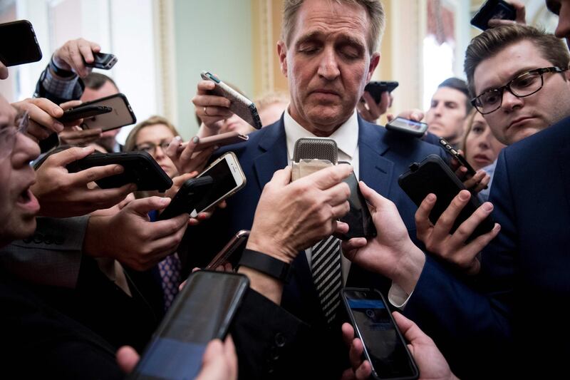 US Senator Jeff Flake speaks with reporters after a meeting with Senate Majority Leader Senator Mitch McConnell about the Judge Brett Kavanaugh nomination on Capitol Hill on September 28, 2018 in Washington, DC. The US Senate Judiciary Committee gave its backing to Brett Kavanaugh, Donald Trump's embattled pick for the Supreme Court, one day after he fought off allegations of sexual assault at a dramatic day-long hearing that riveted the nation. / AFP / Brendan Smialowski
