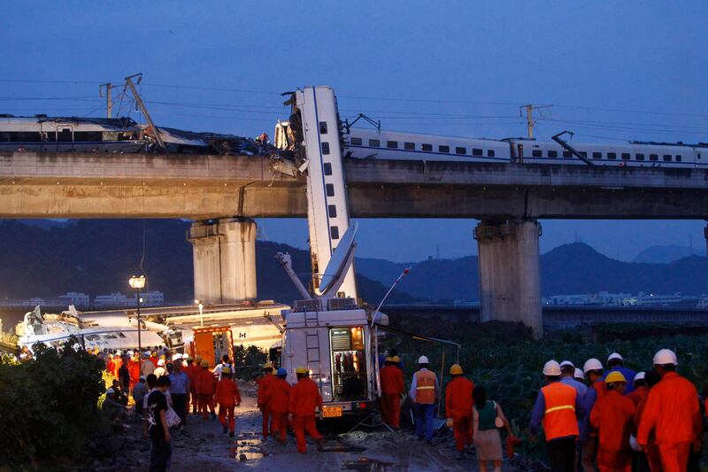 Rescuers carry out rescue operations after two carriages from a bullet train derailed and fell off a bridge in Wenzhou, Zhejiang province July 24, 2011. At least 32 people died when a high-speed train smashed into a stalled train in China's eastern Zhejiang province on Saturday, state media said, raising new questions about the safety of the fast-growing rail network. The accident occurred on a bridge near the city of Wenzhou after the first train lost power due to a lightning strike and a bullet train following behind crashed into it, state television said. REUTERS/Aly Song  (CHINA - Tags: DISASTER TRANSPORT) *** Local Caption ***  SHA104_CHINA-TRAIN-_0723_11.JPG